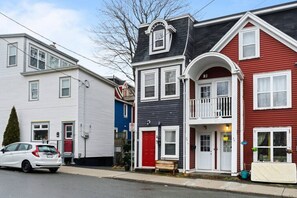 The front exterior of the house, among the colourful rows of houses in downtown St John's.