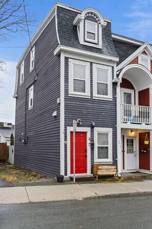 The property's main entrance is adorned with this red door that immediately draws your attention.