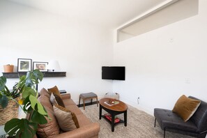 Living space with dedicated workspace, library, and flexible seating areas