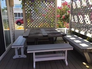 eating table on outside deck. Sliding doors into dining room.