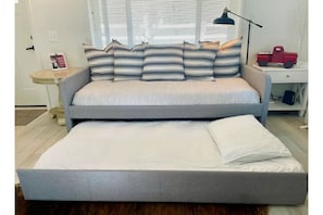 Trundle sofa becomes two single beds.
