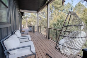 This corner of our 1/2 wrapped deck has a chair swing and two comfy chairs.