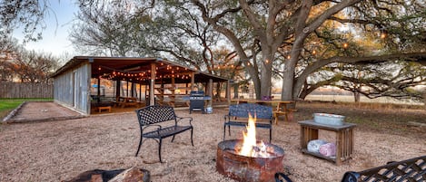 Gather around the firepit, play cornhole, and grill at the shared barn for endless outdoor fun.