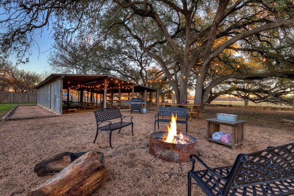 Gather around the firepit, play cornhole, and grill at the shared barn for endless outdoor fun.
