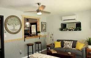 The kitchen’s pass-through window into the living room adds to the openness. 