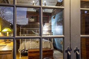 Early 1900 carriage house doors look out onto the covered porch.