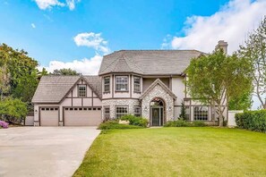 Grand storybook estate with stone façade and lush green lawn!