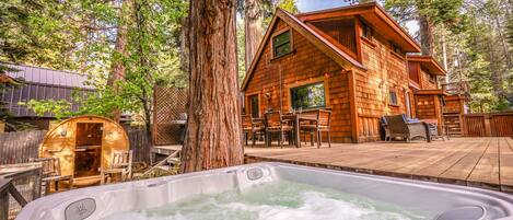 Expansive back yard with hot tub, sauna, and decks for entertaining. 