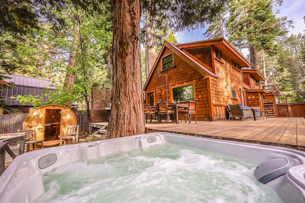 Expansive back yard with hot tub, sauna, and decks for entertaining. 