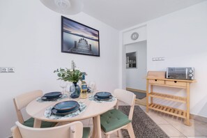 A dining area with a wooden table, stylish chairs, and a bright, airy atmosphere.
