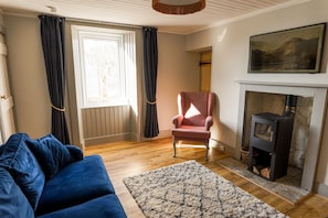 The lounge with the log burner. There is plenty of wood available for guests.