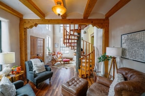 A living room with a spiral staircase.