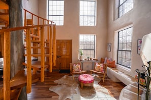 A living room with a spiral staircase.