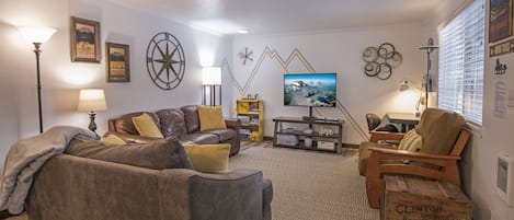 Comfy living room with remote work desk by the 3 sisters mtns on the far wall. 