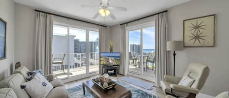 Spacious living room with bright glass doors bringing natural light into the condo.