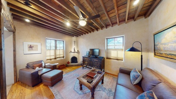 Cozy living room with Fire TV and wood burning kiva fireplace