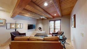 Living room with smart TV and kiva fireplace
