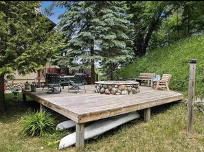 Back of house fire pit and large deck. 