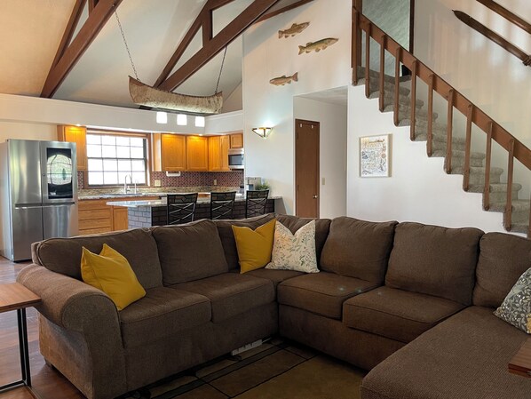 Main living area on the primary level of the cabin, looking out from the hearth