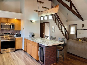 Open plan kitchen, featuring an island counter and beverage cooler