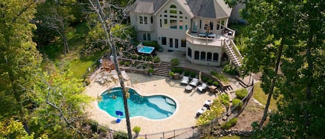 Aerial view of pool, hot tub, and tranquil setting of Lake Charrette Retreat!