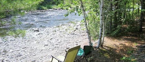 Just one of many places along 300' stream frontage to sit and relax