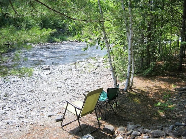 Just one of many places along 300' stream frontage to sit and relax