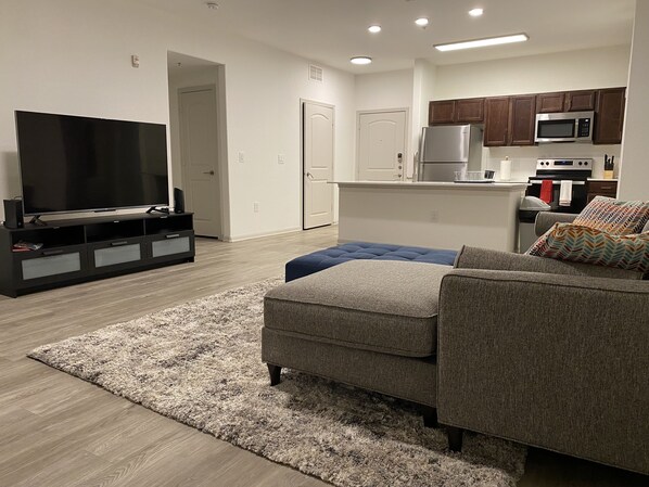 Comfy spacious living room with 65 inch smart TV 