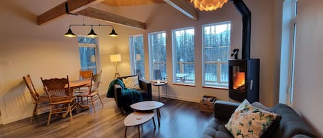 Stylish second story living room with a woodstove and views