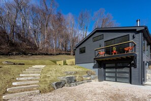 Modern home is graphite with black windows and accents.  