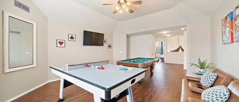 Game room with pool, air hockey, and ping pong tables, sofa bed and ROKU TV!.