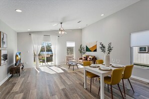 spacious living area with dinning table and smart tv