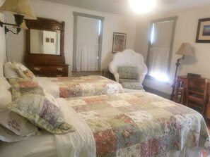 Wicker bedroom with two cozy twin sized beds and dresser.