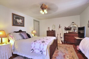 Master bedroom with plush queen-sized bed. Roomy closet and dresser for storage.