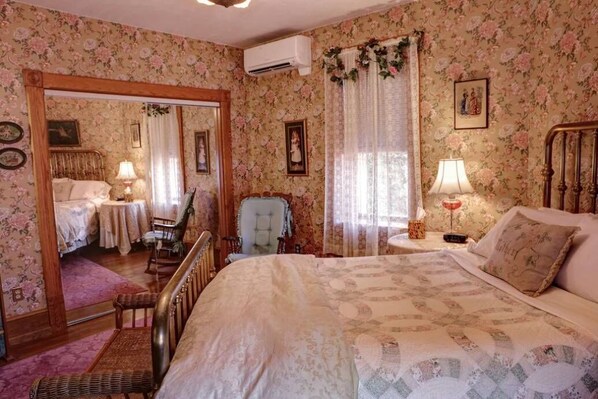 Comfy queen sized bed in spacious bedroom with large closet.