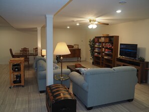 LIVING ROOM:  The apartment has a very comfortable living room with a sleeper sofa, comfy chair, ceiling fan, table, and television.