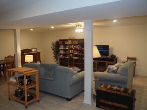 LIVING ROOM:  The apartment has a very comfortable living room with a sleeper sofa, comfy chair, ceiling fan, table, and television.