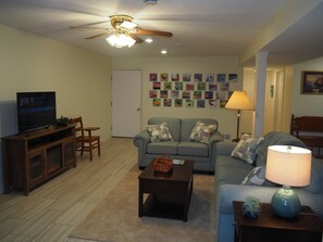 LIVING ROOM:  The apartment has a very comfortable living room with a sleeper sofa, comfy chair, ceiling fan, table, and television.
