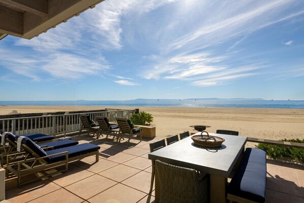 Beachfront Patio with Ample Seating and Sweeping Ocean Views