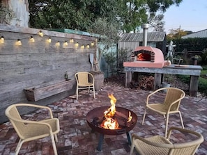 Outdoor firepit and wood-fired pizza oven