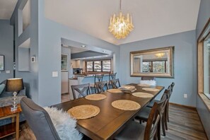 Large farm table with seating for 8 plus two more at the bar.