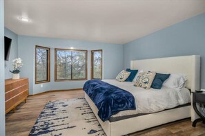 Large master bedroom with a plush king-size bed with down duvet & luxury linens.