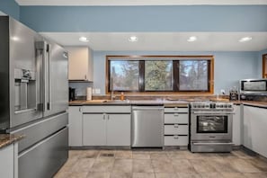 Full-size kitchen with brand-new stainless steel appliances. 