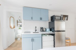 Small kitchenette with dining and silverware essentials.