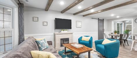 Living room with TV and fireplace.