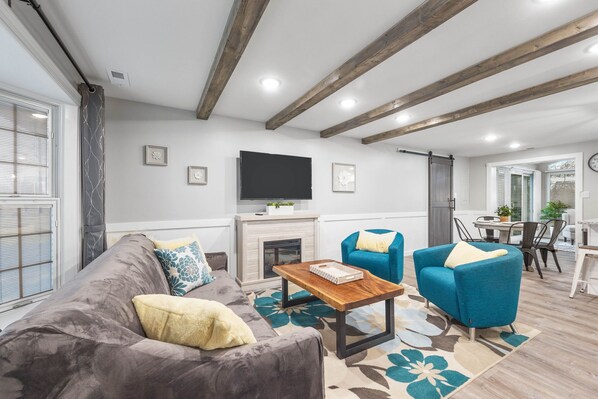 Living room with TV and fireplace.