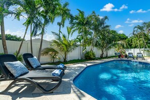 There are 6 lounge chairs and a hammock surrounding the pool deck.