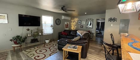 Roomy living room with very comfy leather couch and recliner