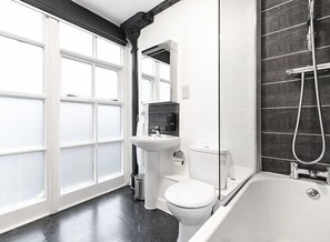 Large bathroom with bathtub / shower combo