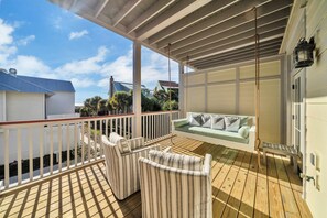 South deck with ocean view and swing bench .